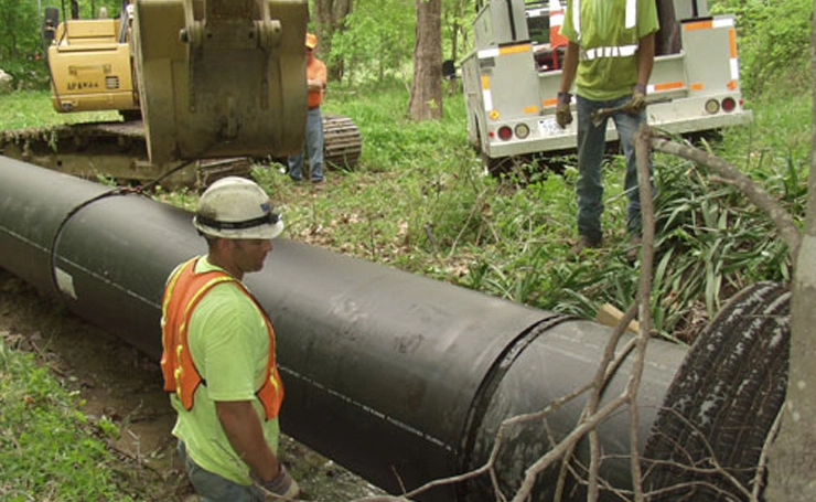 workers installing pipe